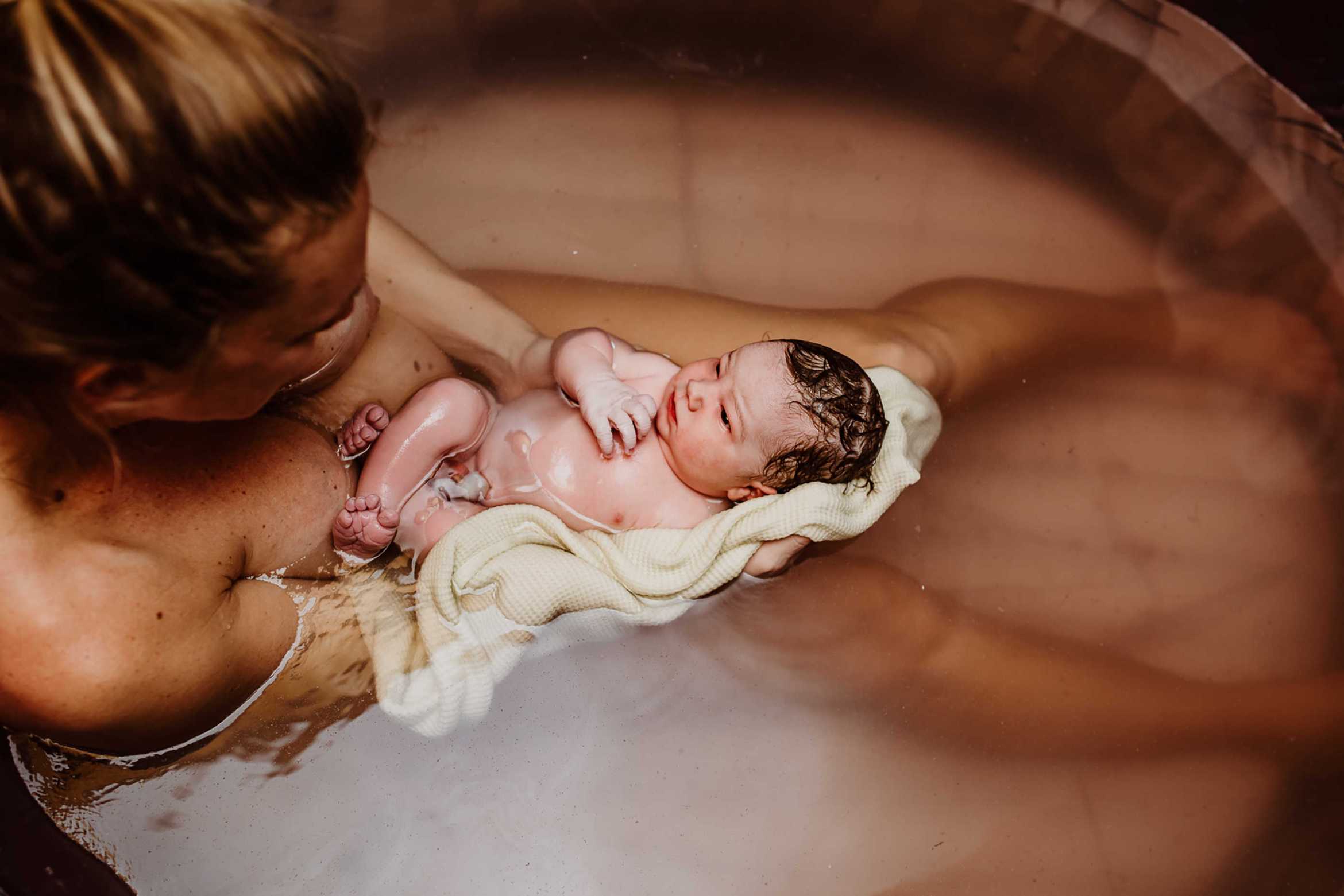 Woman in bathtub who has just given birth